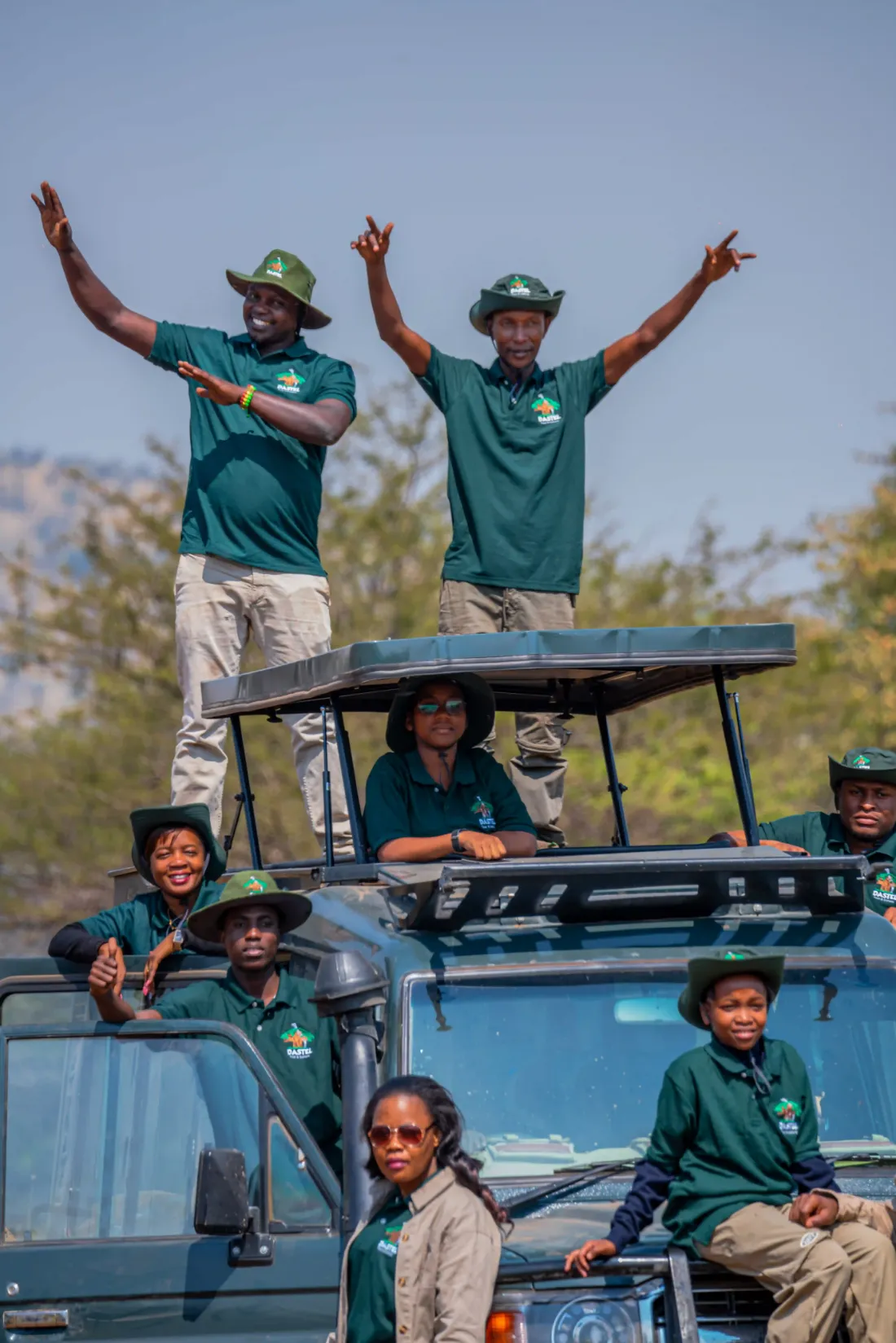 The Dastel Tour and Safaris team cheering from their safari vehicle