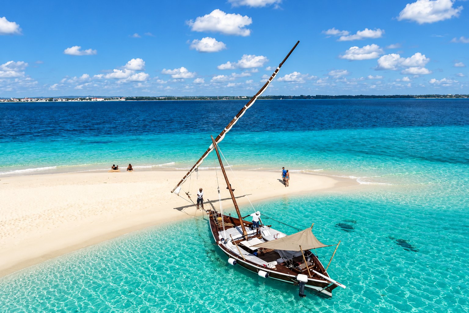 A traditional dhow beside a white sandbar in Zanzibar